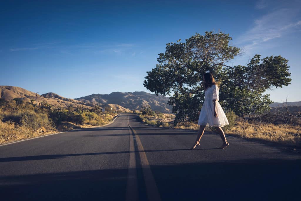 Girl walking across road